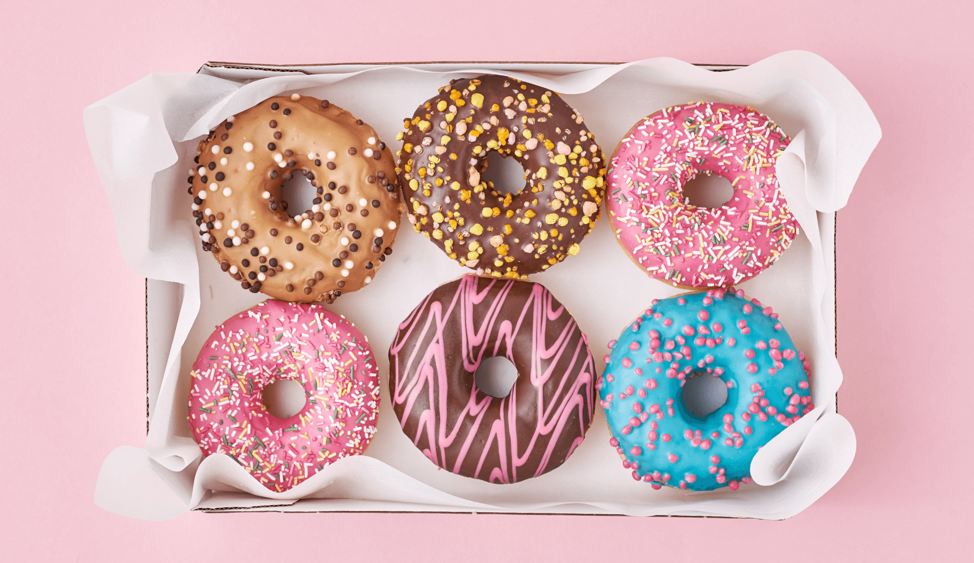 bunte donuts in einer box als symbol für vielfalt und kreativität
